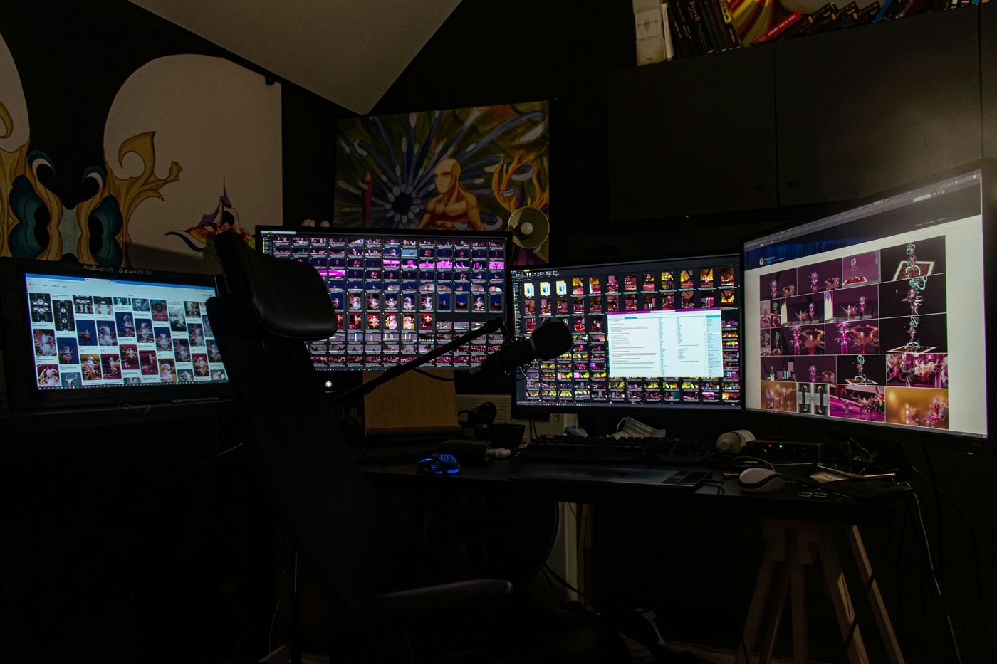 A person sitting in front of three computer monitors