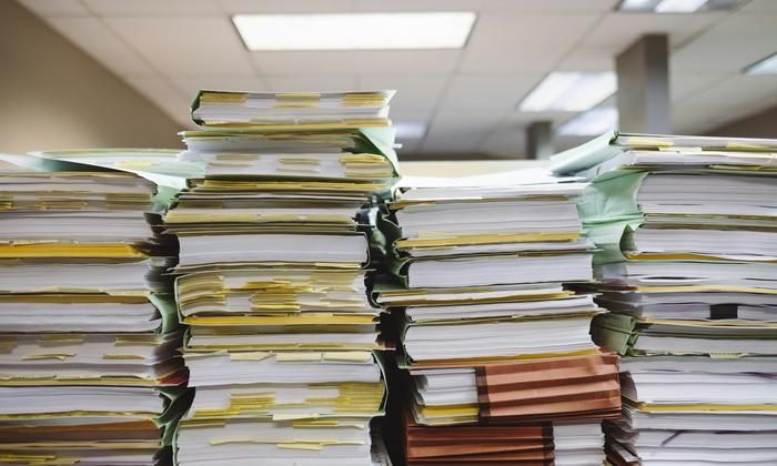 Stacks of paper documents and file folders